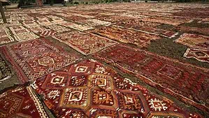 Washed rugs are laid on the floor in a rug cleaning facility waiting to dry. Washed rugs are laid on the floor in a rug cleaning facility waiting to dry.