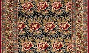 Partial image of a wool floral Persian rug with red flowers. Partial image of a wool floral Persian rug with red flowers.
