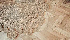 A round shape braided rug on a light color hardwood floor A round shape braided rug on a light color hardwood floor