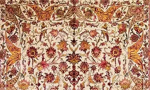 A portion of a hand knotted Persian Isfahan rug made of wool and silk in beige, red, green, pink, brown and gold colors. A portion of a hand knotted Persian Isfahan rug made of wool and silk in beige, red, green, pink, brown and gold colors.