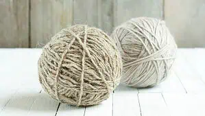 Two wool balls in beige and light brown colors