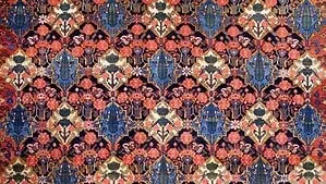 Image of a Persian rug with black, blue, green and red colors Image of a Persian rug with black, blue, green and red colors