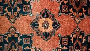 A small portion of a tribal Persian rug with diamond shape pattern A small portion of a tribal Persian rug with diamond shape pattern