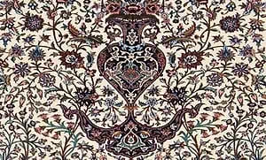 A floral Perian rug and a vase of flower A floral Perian rug and a vase of flower