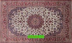 An antique Persian Isfahan rug with beige color in the main field and red in the borders. An antique Persian Isfahan rug with beige color in the main field and red in the borders.