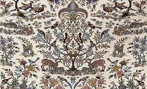 A portion of a Persian Isfahan rug with beige color showing animal and birds with nest. A portion of a Persian Isfahan rug with beige color showing animal and birds with nest.