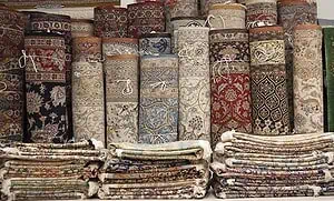 Variety of Persian rugs are rolled and stacked. Variety of Persian rugs are rolled and stacked.