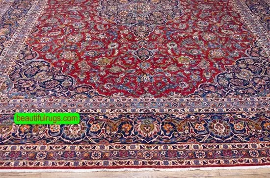 Semi antique Persian Kashan rug with orange red and navy blue color. Size 11.3x14.7.